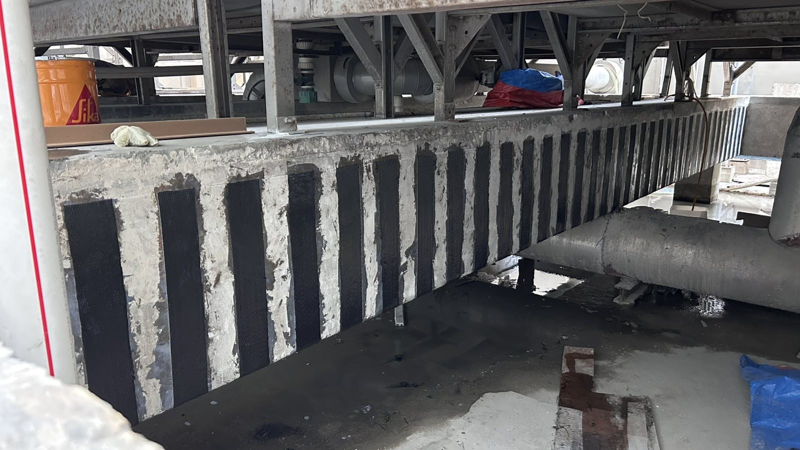 Reinforcement strips along a cooling-tower support beam at bai Hotel.