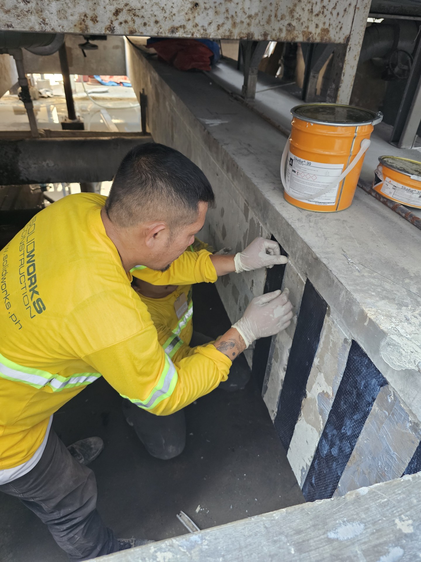 Application work on a cooling-tower support beam.