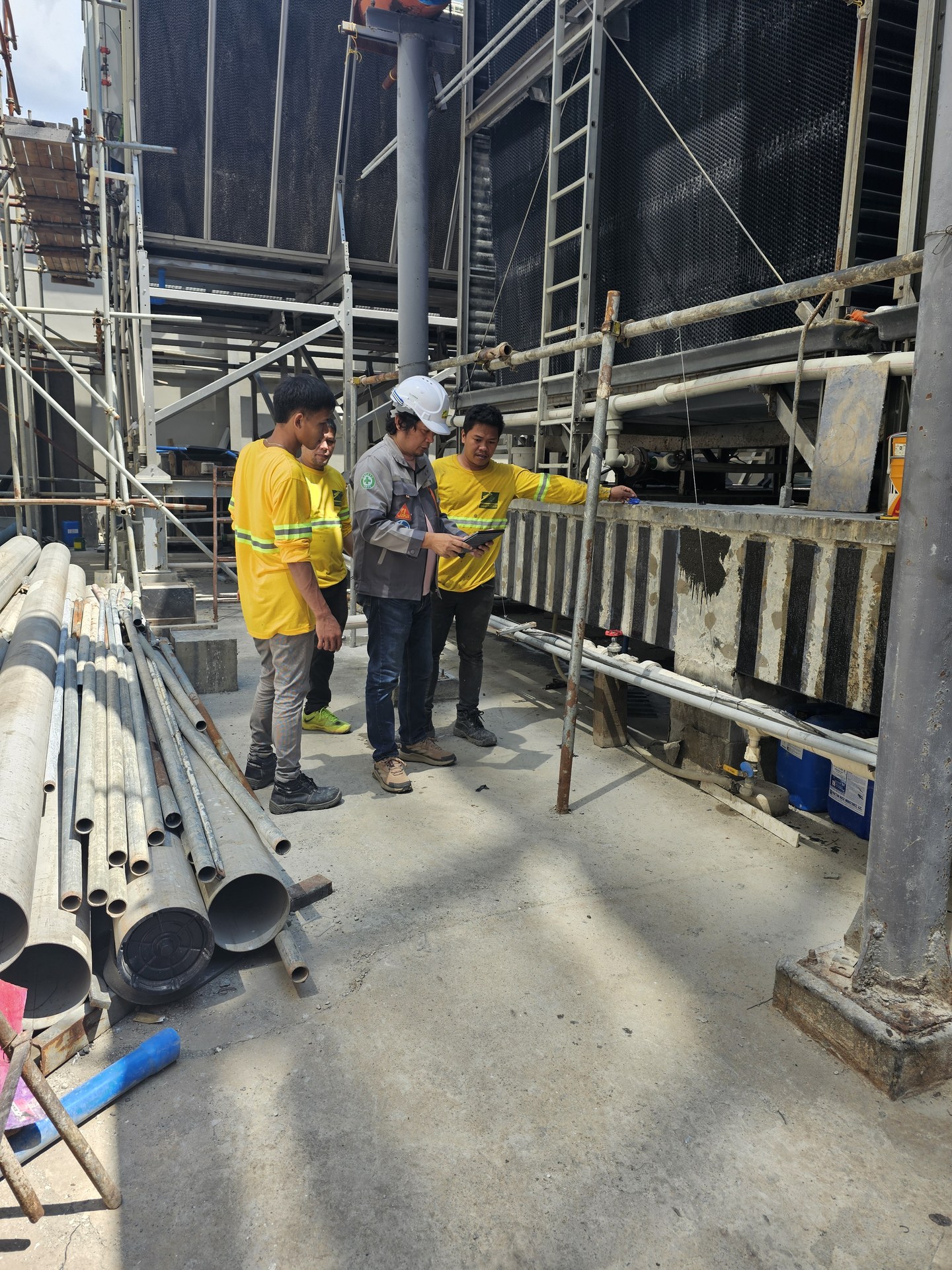 Site team beside the cooling-tower structure.
