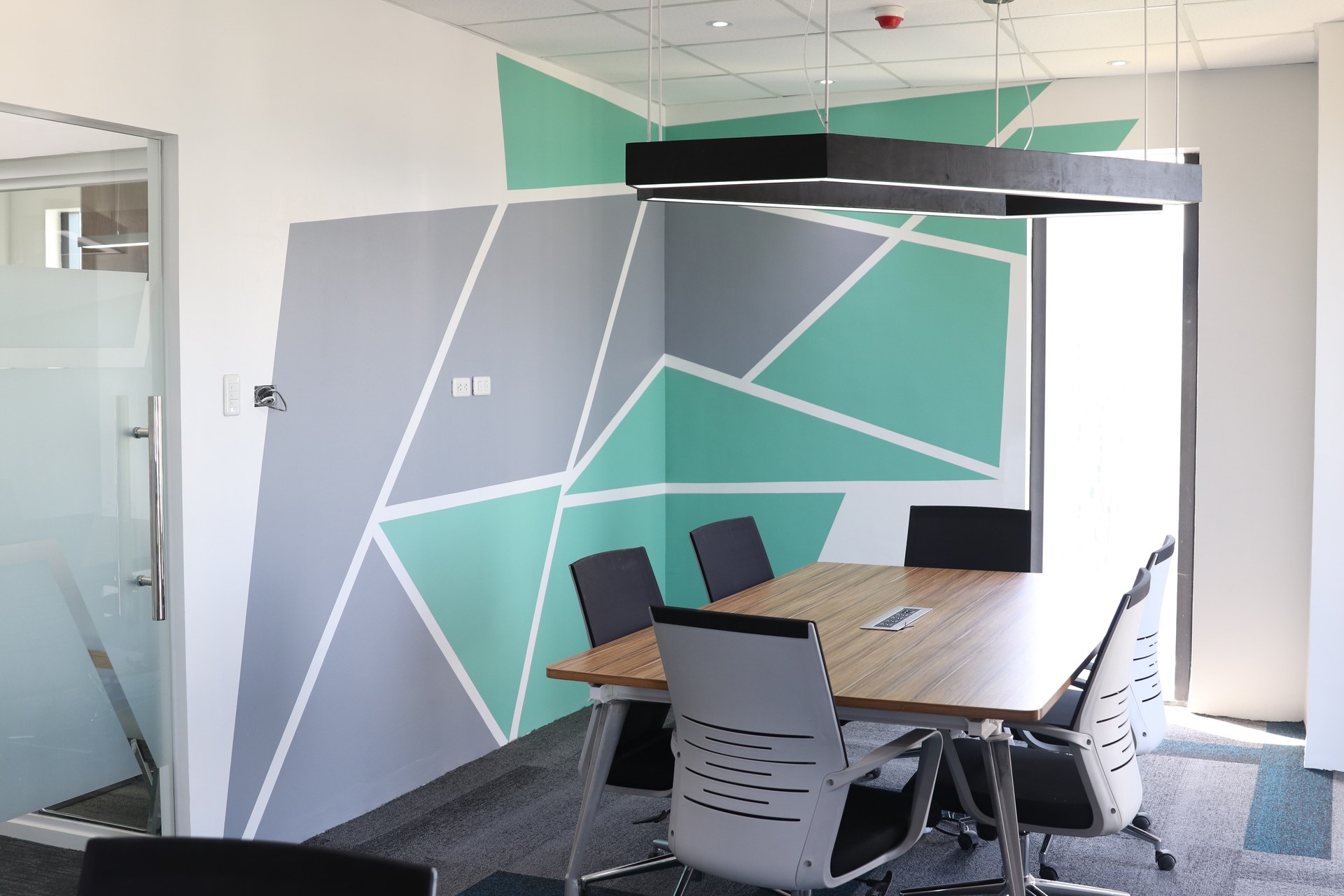 Meeting area with geometric feature wall.
