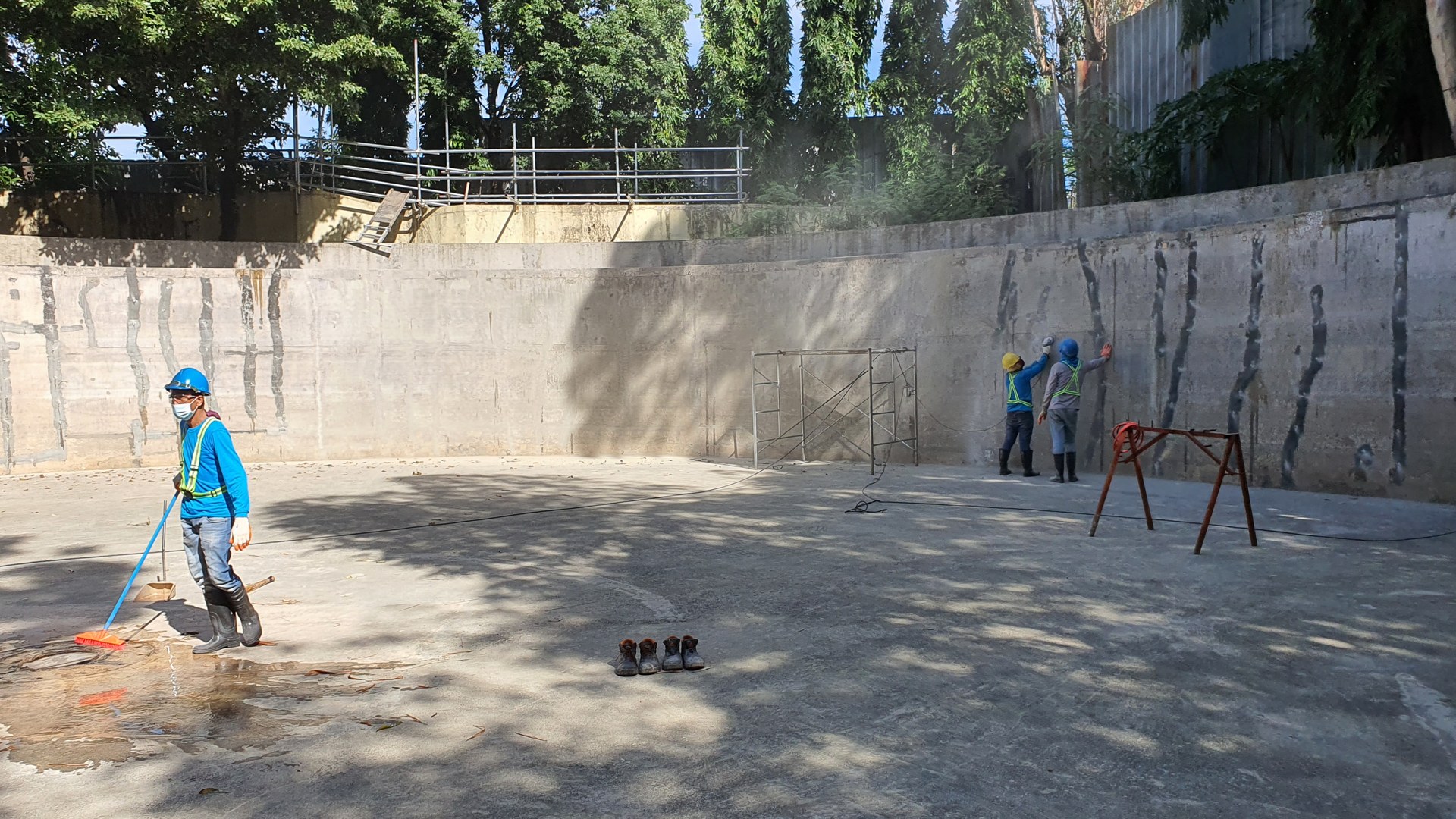 Work in progress inside the drained treatment basin.