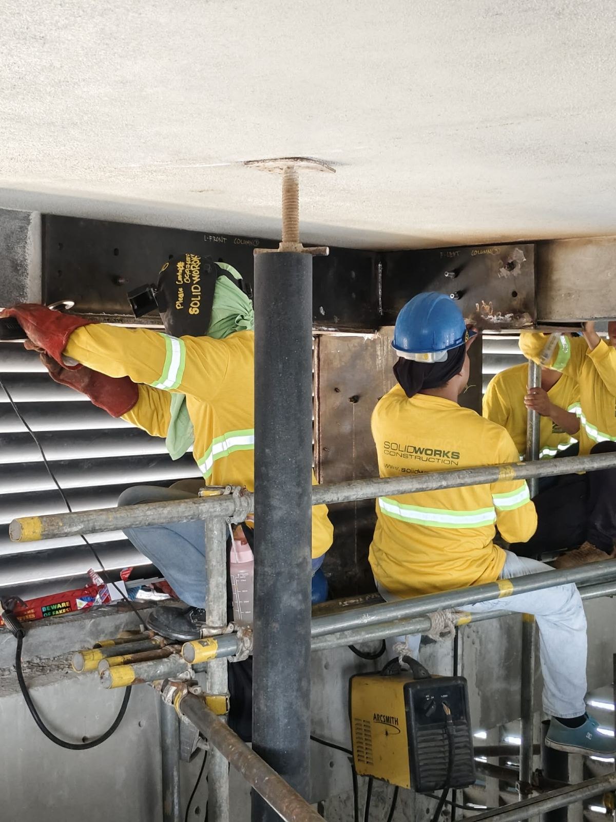 Crew working on a roof-column steel assembly at bai Hotel